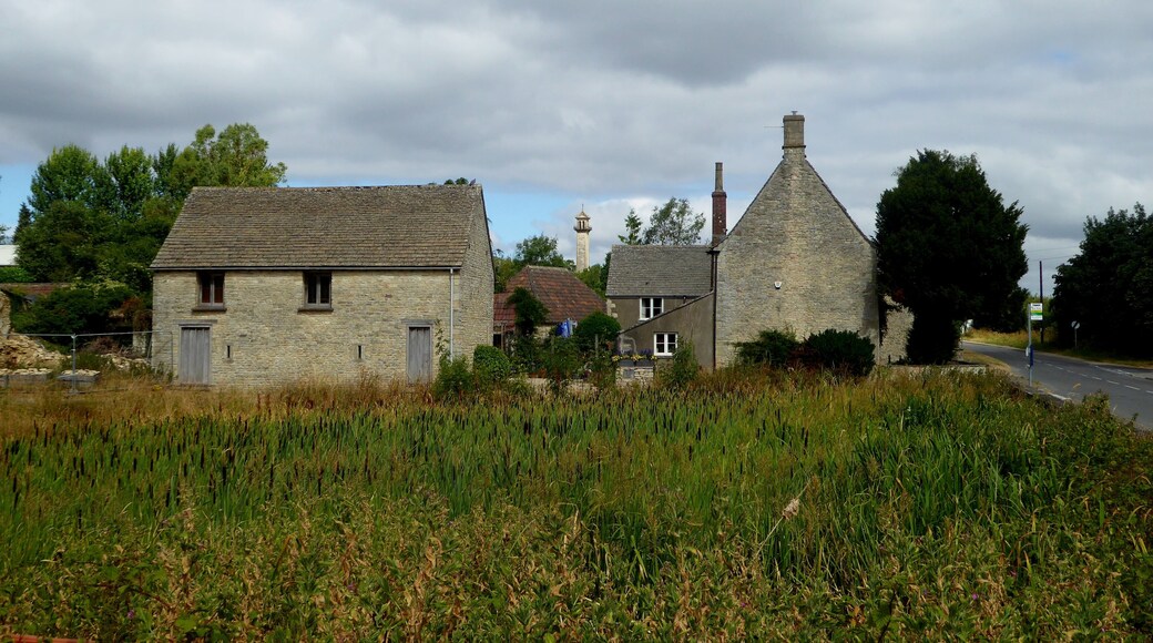 Hawkesbury Upton pond (in the foreground) with farm buildings behind. The Somerset Monument can be seen in the distance.