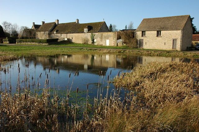 Hawkesbury Upton Cottages reflected in a pond in the village of Hawkesbury Upton. The Cotswold Way passes in front of these cottages.