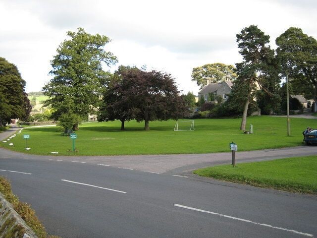 The village green in Romaldkirk, County Durham This photograph shows a view of the village green in Romaldkirk, a small village in the Teesdale area of County Durham. The picture was taken from the gated entrance to the church grounds looking in a south-easterly direction towards Low Garth.