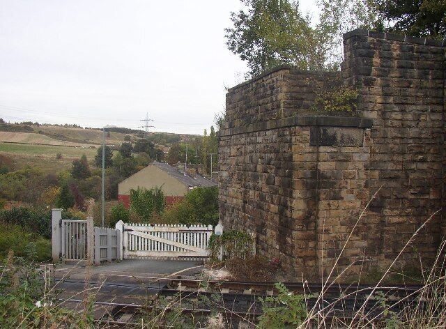 Lady Ann Level Crossing, Batley. This is at the top of Primrose Hill, looking east from Stoney Lane. The railway is the main line from Dewsbury to Leeds, and the bridge abutment was for the Batley and Adwalton Line. The bridge was over the level crossing.