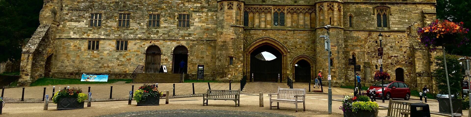 A historic stone castle with multiple towers and arched windows.