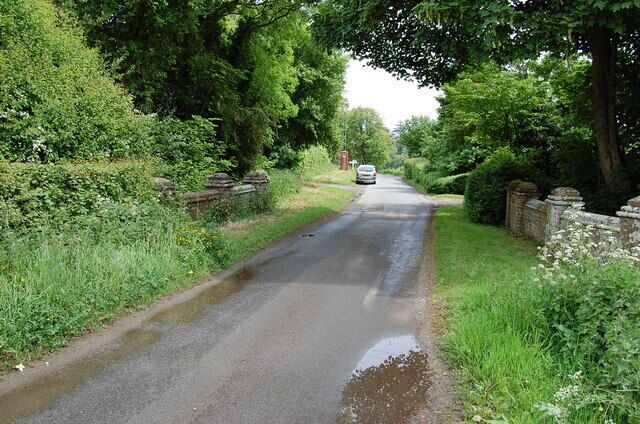 Bridge over unknown stream Junction and signpost in distance.