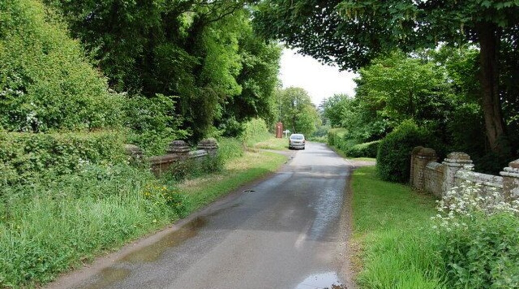 Bridge over unknown stream Junction and signpost in distance.