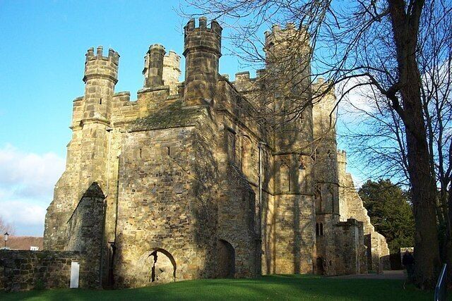 A historic stone castle with multiple towers and arched windows.