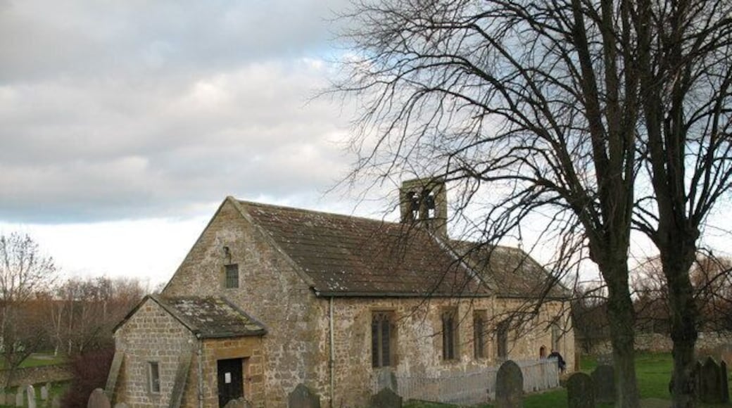 St Andrew's Church Finghall., near to Finghall, North Yorkshire, Great Britain. Although this 12th century church is now the parish church of Finghall, it must once have served the villagers of nearby Akebar. Fields close to the church show earthworks from a former village, whilst other fields are full of residential caravans.