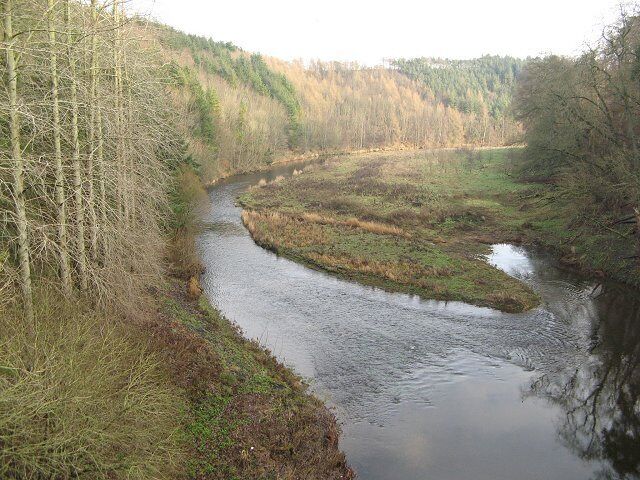 Newton Braes and Whiteadder Water View downstream from Hutton Bridge. The steep slopes are wooded on both sides of the river, which has cut down a long way from the general land level here.