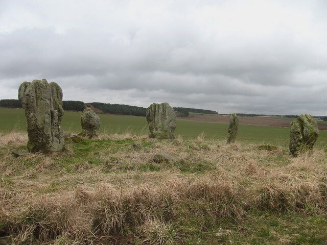 Duddo Five Stone Circle. A bronze age stone circle, 4000 years old with a cremation pit at its centre. The stones are naturally shaped but have been narrowed and smoothed at the bases. Local names are 'The Women' and 'The Singing Stones'. The circle stands in the middle of a field that is in use.
