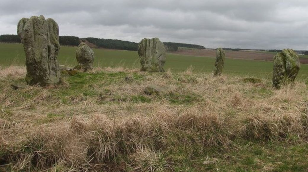 Duddo Five Stone Circle. A bronze age stone circle, 4000 years old with a cremation pit at its centre. The stones are naturally shaped but have been narrowed and smoothed at the bases. Local names are 'The Women' and 'The Singing Stones'. The circle stands in the middle of a field that is in use.