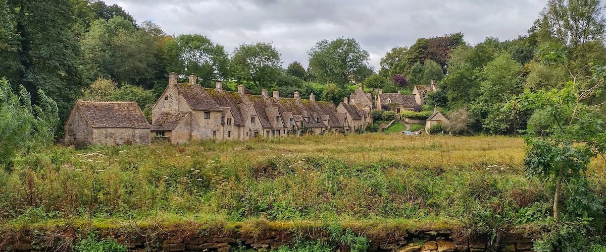 Bibury is a village and civil parish in Gloucestershire, England. It is on both banks of the River Coln which rises in the same District and which is a Thames tributary. The village is centred 6 ¹⁄₂ miles northeast of Cirencester. Wikipedia