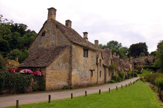 A row of traditional stone houses with a pathway in between.