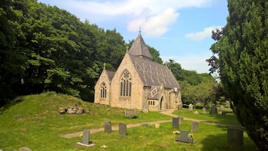 Parish church viewed from the west: 1862-3 rebuilding, by S.S. Teulon for Rev. Daniel Capper of Newbiggin, of 1781 church on medieval site. The ruins of a 16th-century pele tower are in the foreground.