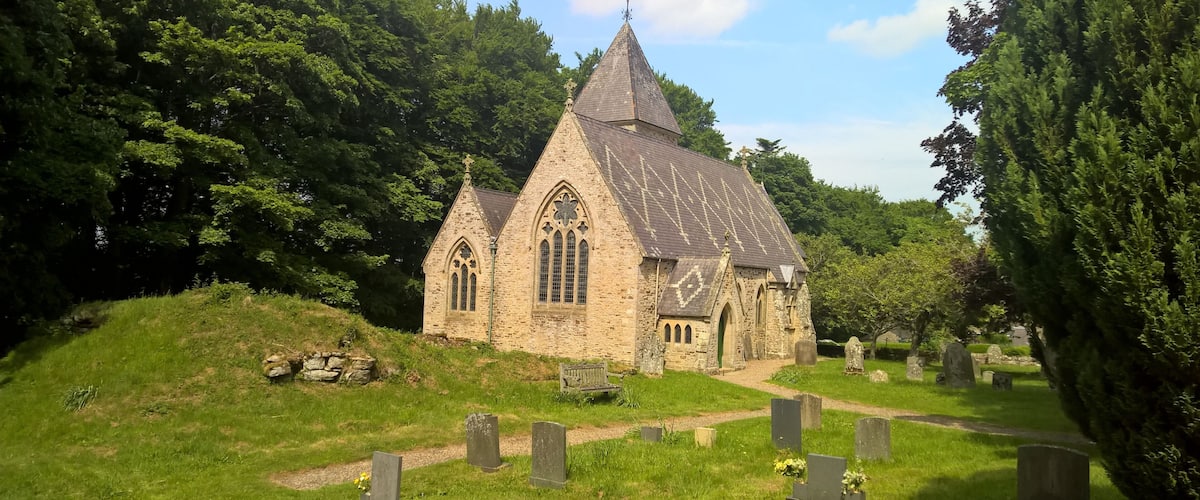 Parish church viewed from the west: 1862-3 rebuilding, by S.S. Teulon for Rev. Daniel Capper of Newbiggin, of 1781 church on medieval site. The ruins of a 16th-century pele tower are in the foreground.