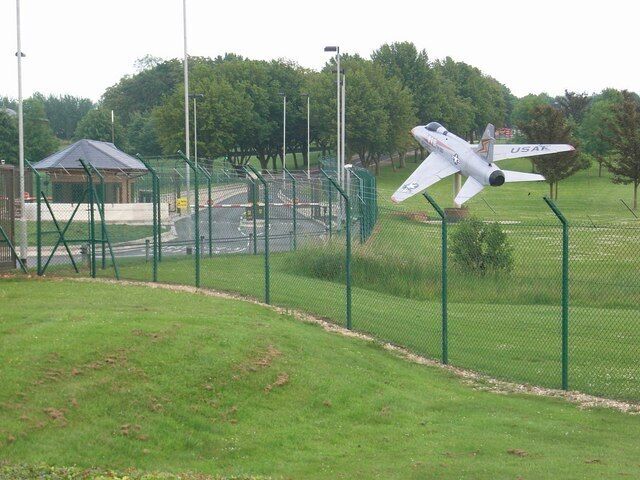 A North American F-100D-10-NA Super Sabre (s/n 54-2212) as a gate guard at the U.S. base at RAF Croughton, Northamptonshire (UK). This aircraft had been delivered to the French Armée d'l Air. It was later returned to the U.S. Air Force andplaced on display within the USAF base at RAF Sculthorpe, Norfolk (UK). Later it was moved to RAF Upper Heyford, Oxfrodshire (UK), and painted as USAF "63000" (F-100D-65-NA 56-3000). It was moved to RAF Croughton when RAF Upper Heyford was closed.