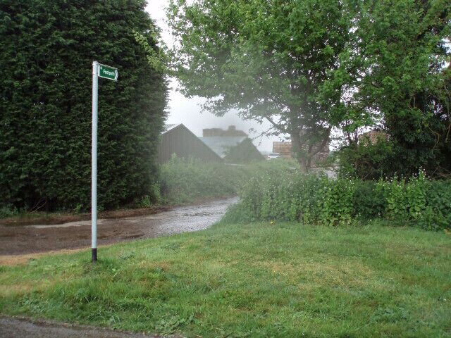 Public footpath through a timber yard This footpath goes right through the middle of the timber yard, with large stacks of planks all around.