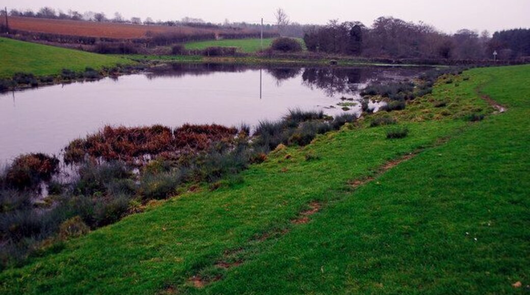 Small lake near Charlton A minor road at the southern end of this lake forms a dam.