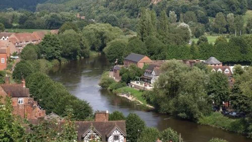 Ein Fluss fließt durch eine von Hügeln umgebene Stadt.