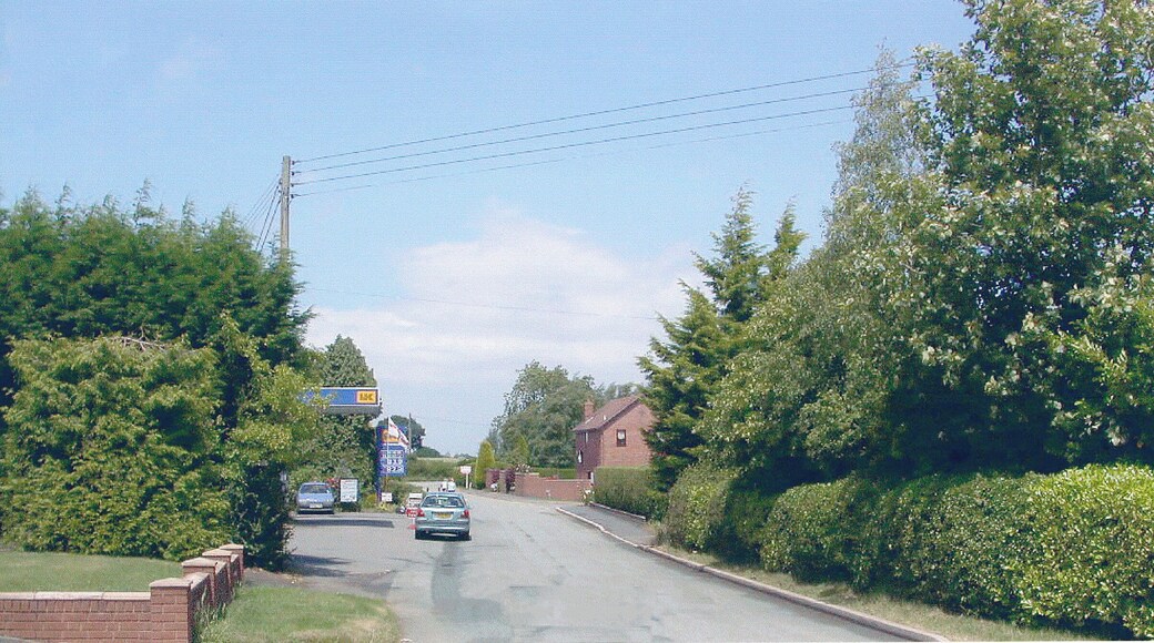 Ditton Priors: site of former station. View NE on the road to Middleton Priors: the terminus of the Cleobury Mortimer & Ditton Priors Light Railway had been on the right. The line from Cleobury Mortimer had been closed to passenger traffic since 26/9/38 (to goods since 11/9/39), but had then been acquired by the War Department to serve Armaments Depots at Ditton Priors until 30/6/65. Since then the station site has been a Trading Estate.