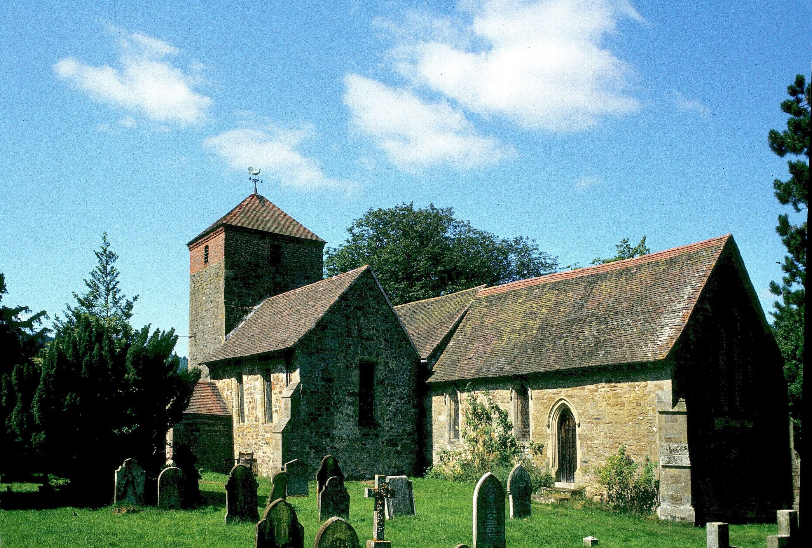 A church with a bell tower and a graveyard.