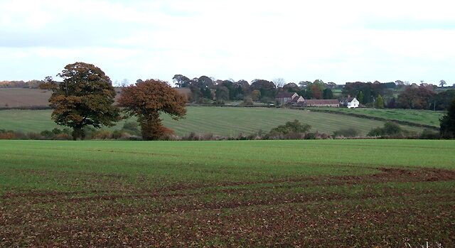 Crop Fields, Middleton Priors, Shropshire The line of a brook crossing the picture is revealed by the trees and shrubs. North Farm is the distant cluster of buildings.