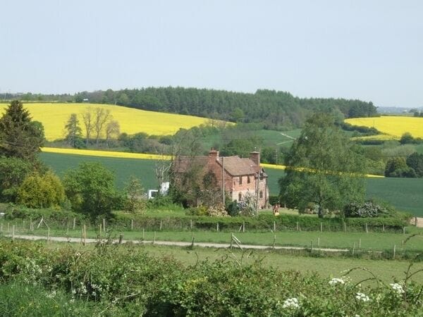 Isolated farmhouse near Nordley The oilseed rape crop is in full flower all over Shropshire.