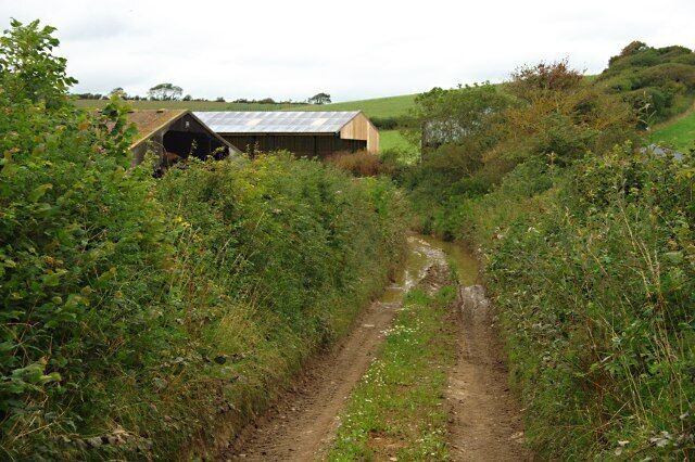 Milvers Lane Modern barns and some flooding on this farm lane as it goes through the dip.