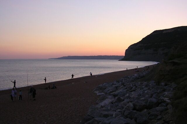 Beach at dusk, Seatown View east along the beach at Seatown, with Golden Cap rising up on the right.