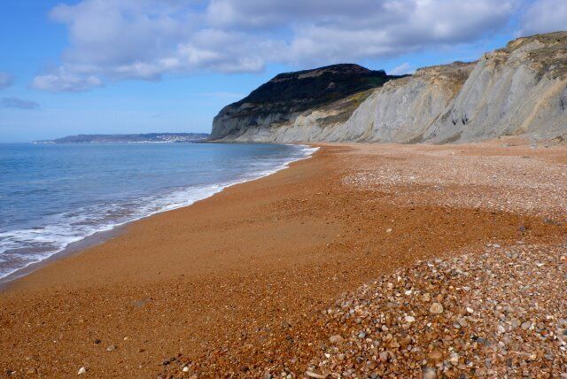 Seatown Beach View west along the beach from close to Seatown. The tide is just below its highest point and the beach is well covered with a deep layer of shingle. The depth of the shingle on the beach can vary by several metres depending on the tide and the weather.