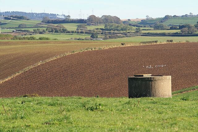 Farmland near Lower Ash I think that the concrete structure is for water storage.