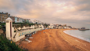 Panoramic image of Viking Bay, Broadstairs, UK on a mild winter day. The elevator shaft to the beach and the row of beach huts can be seen along with the pier.