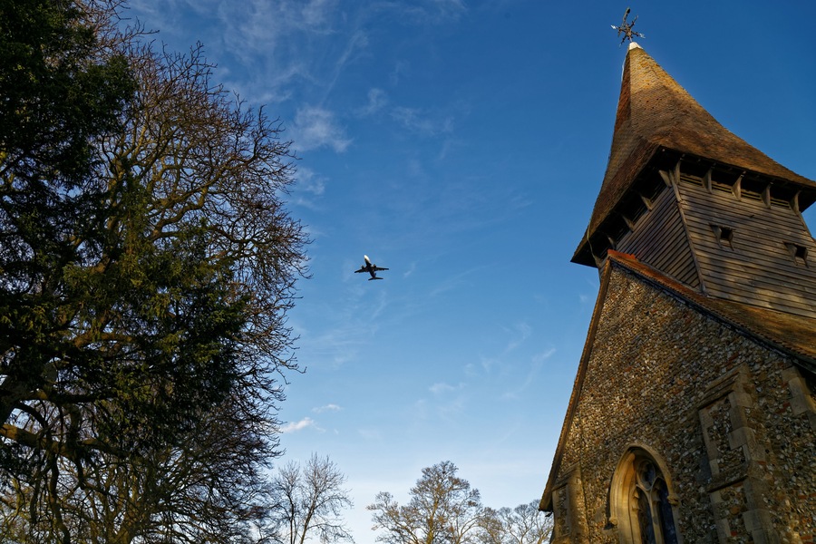 A Ryanair Boeing 737 passenger aircraft in descent to London Stansted Airport over the south west of St Mary the Virgin's Church, Broxted, Essex, England. Software: JPEG file optimized and/or cropped and/or spun with DxO OpticsPro 10 Elite and Adobe Photoshop CS2.