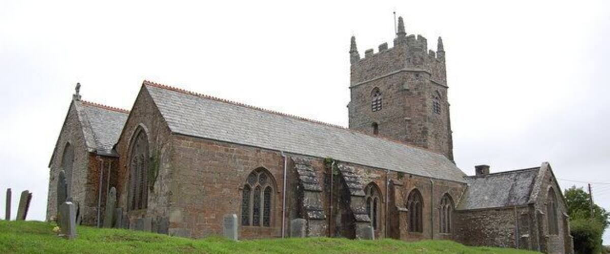 A historic church with a tall tower and arched windows.