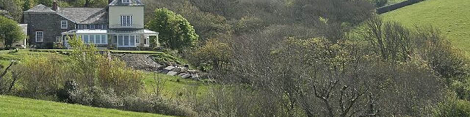 St Gennys: nearing Churchtown With St Gennys church on the skyline. Seen from the link path between churchtown and the South West Coast Path