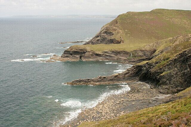 A coastal landscape with rocky cliffs and a rugged coastline.