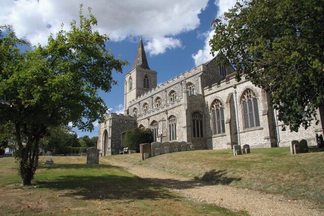 A historic church with a tall spire and arched windows.