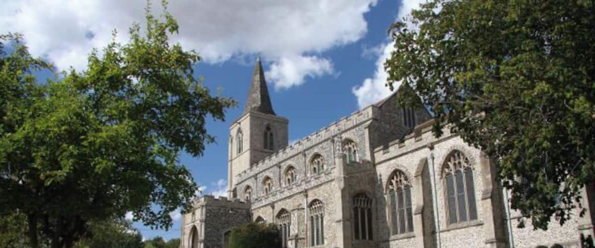 A historic church with a tall spire and arched windows.