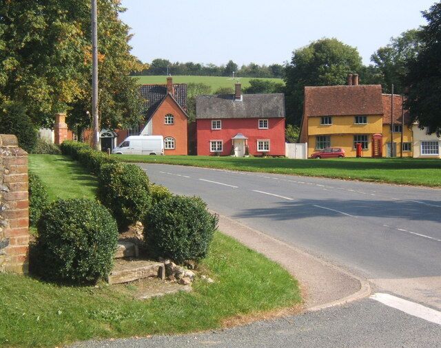 B1066 passing Hartest village green Looking across the front of the village institute from the junction of Somerton Road.