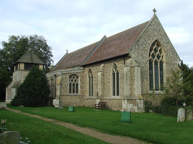 A stone church with a pointed roof and arched windows.