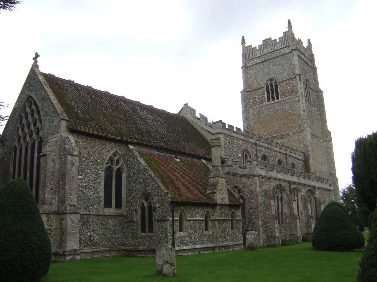 A historic church with a prominent tower and arched windows.