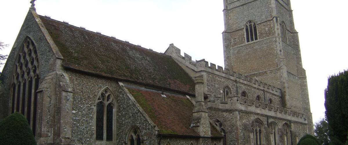 A historic church with a prominent tower and arched windows.