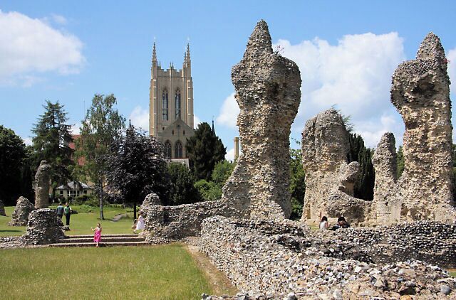 Ancient stone ruins with a church in the background.