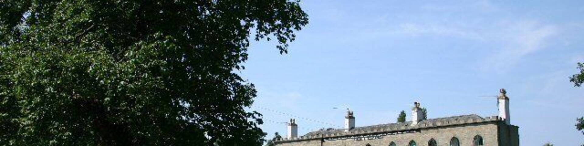 Alms Houses at Hawstead. An inscription, just below the roof line, reads: "These Alms Houses were erected and endowed, for the benefit of the Aged, and Deserving, Poor, Anno 1811, by Philip Metcalfe, Esq."