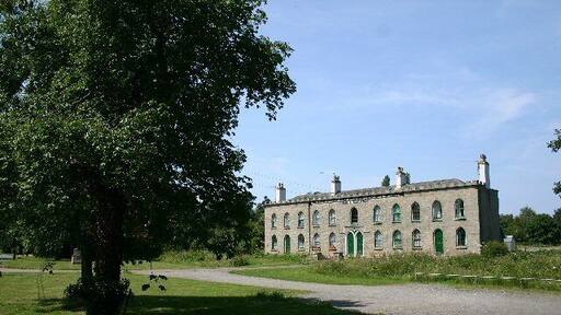 Alms Houses at Hawstead. An inscription, just below the roof line, reads: "These Alms Houses were erected and endowed, for the benefit of the Aged, and Deserving, Poor, Anno 1811, by Philip Metcalfe, Esq."