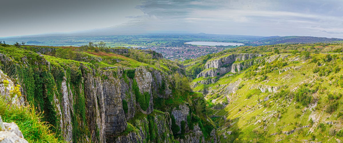 A mountainous landscape with steep cliffs and a valley.