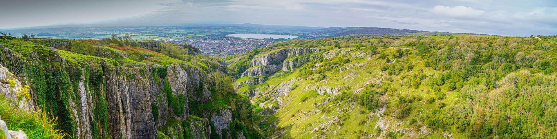A mountainous landscape with steep cliffs and a valley.