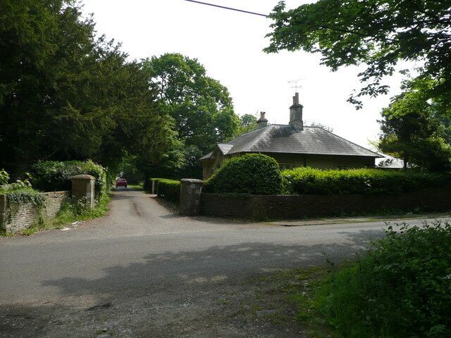 Lodge and entrance to Grittleton Stables. View east across the road to Yatton Keynell.