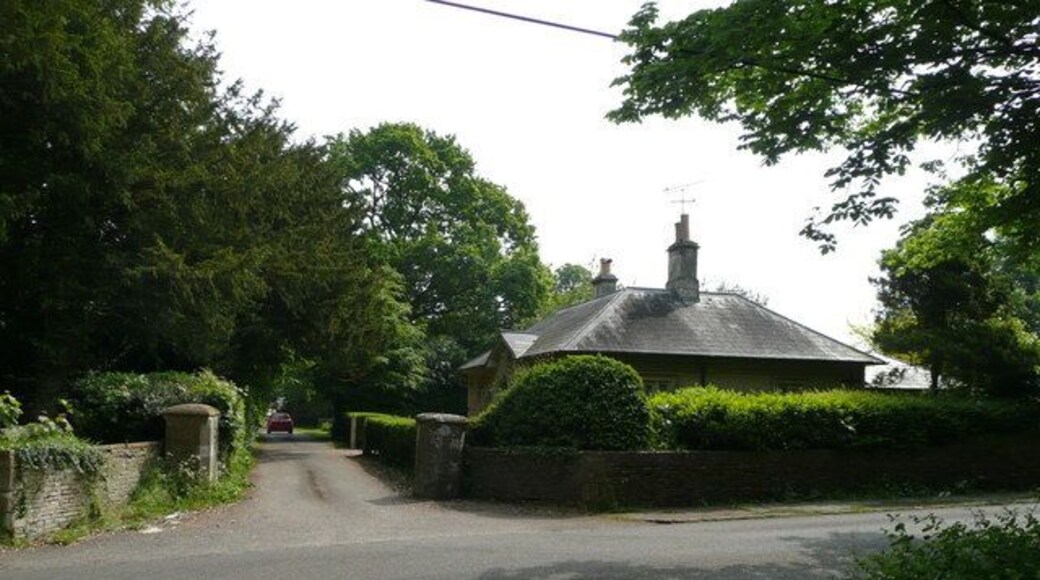 Lodge and entrance to Grittleton Stables. View east across the road to Yatton Keynell.