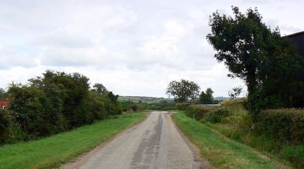 The road past Manor Farm, Grittenham One of the farm buildings can be seen at the right as the road leads away to the east.