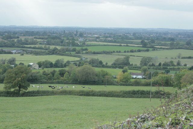 Toward Chippenham from Bencroft Hill Pasture land with cattle, a few farms and other houses, Stanley Lane snaking away further over and Chippenham sprawling in the distance.