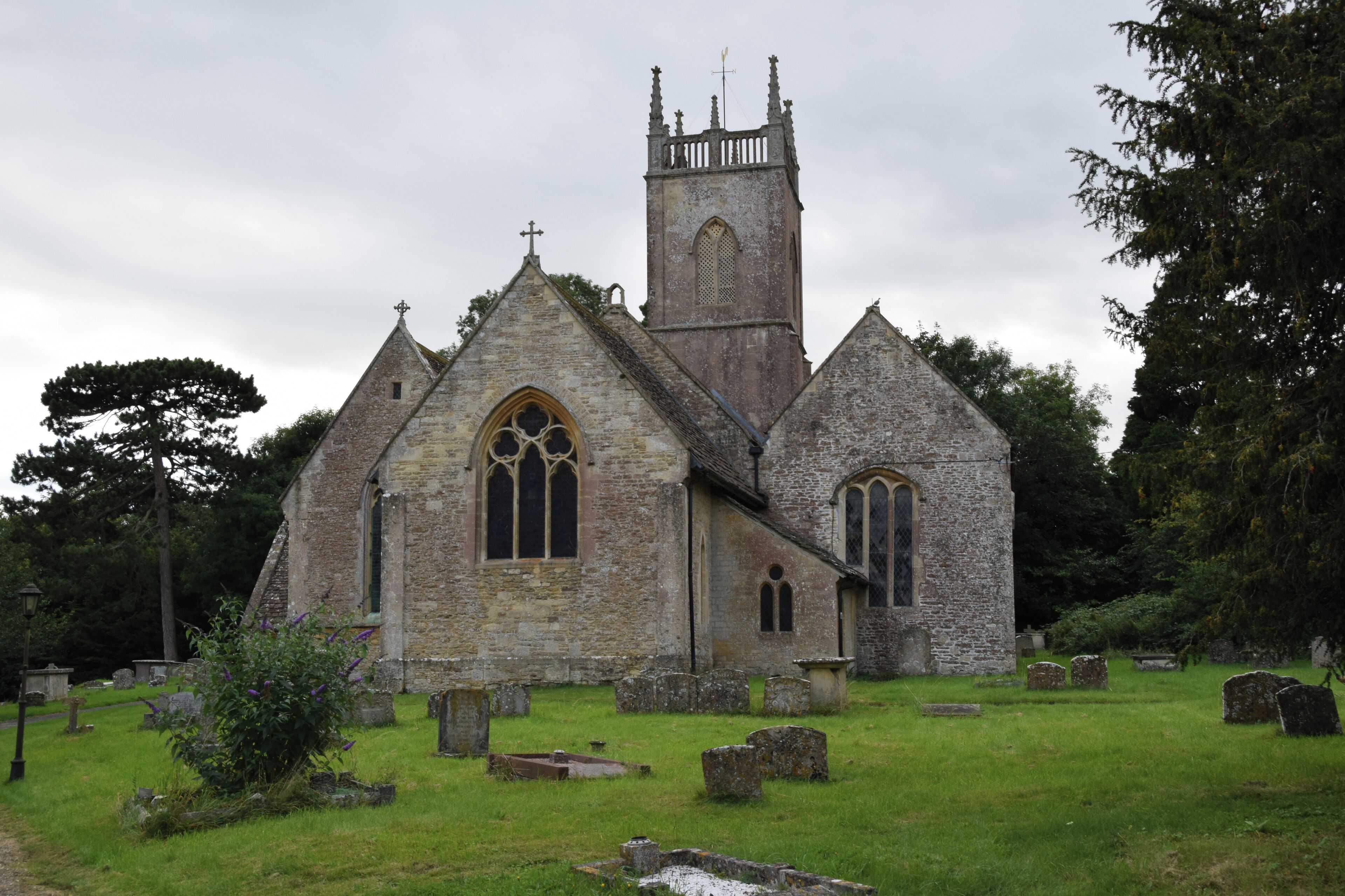 A historic stone church with a tall bell tower and arched windows.