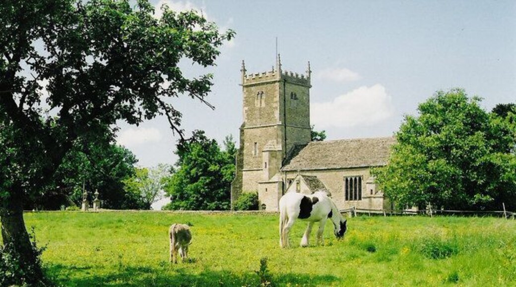 Great Somerford church Animals graze in the sunshine, in front of the Church of St Peter and St Paul.